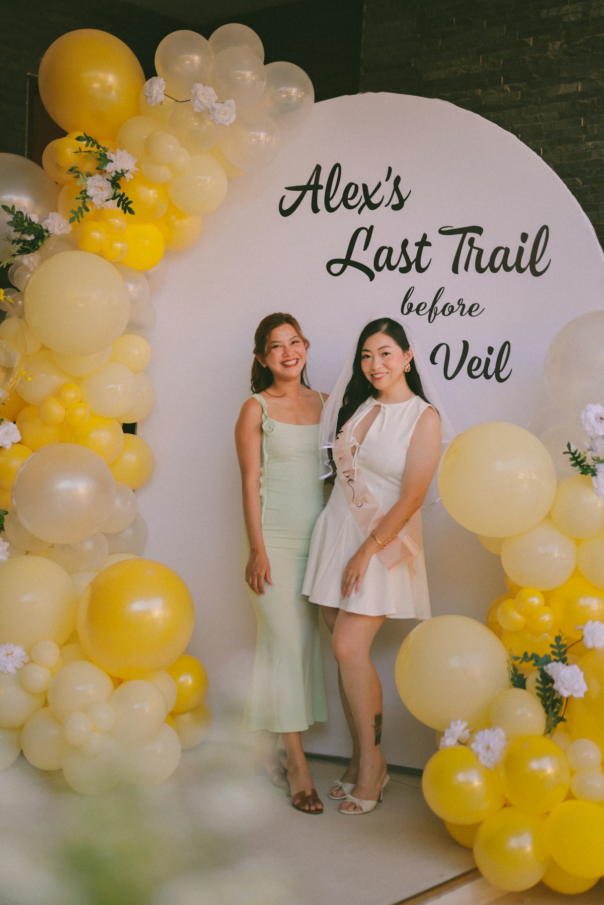 Guests posing together in front of a custom event backdrop