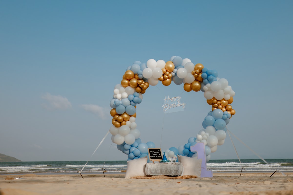 Guests photographed in front of a balloon arch backdrop