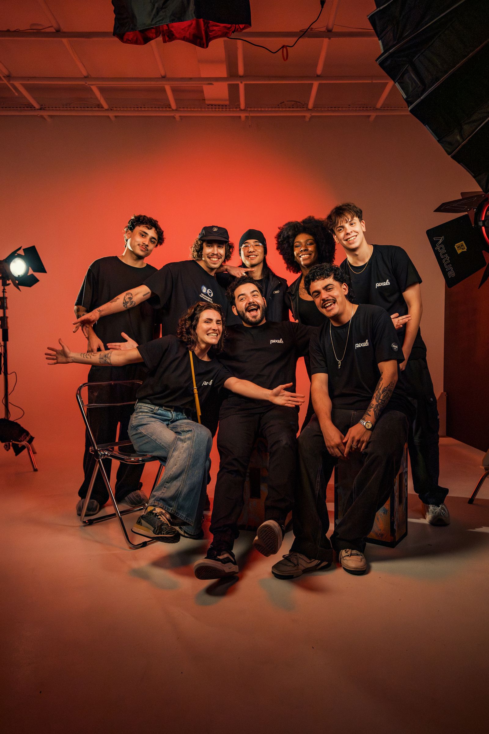 Company team posing together for a group shot in front of a studio photo booth backdrop